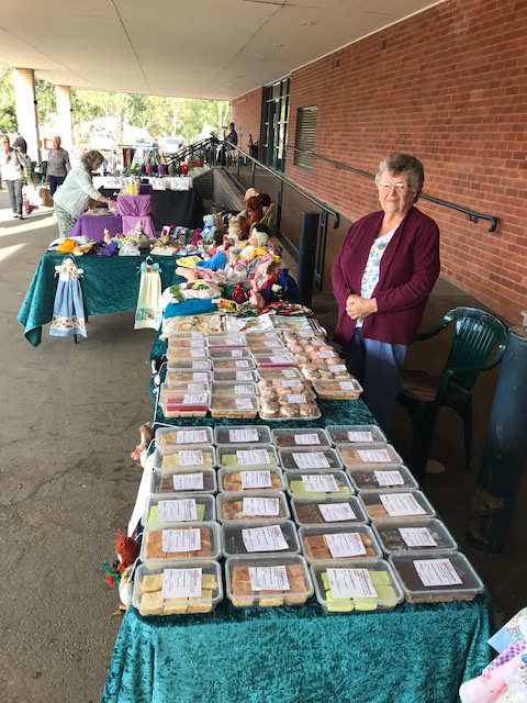 Stall packed with home-baked slices, biscuits and handmade dolls